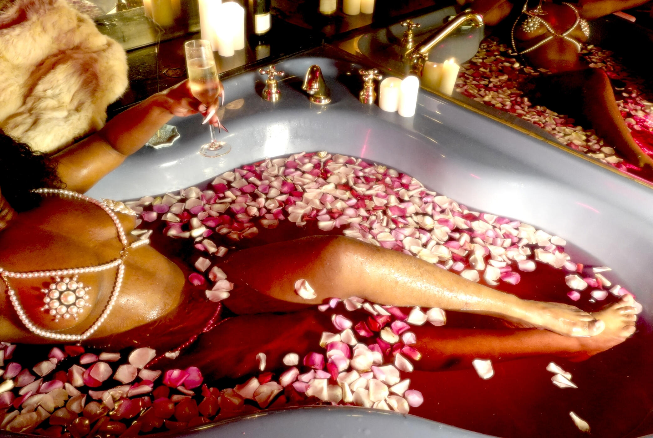 Untitled Black woman in pearl lingerie bathes in a hot tub filled with rose petals